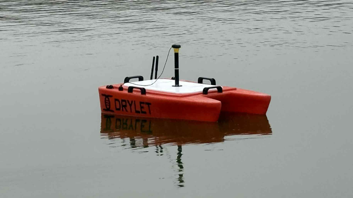 Operator measuring sludge depth in a wastewater lagoon using GPS sonar mapping