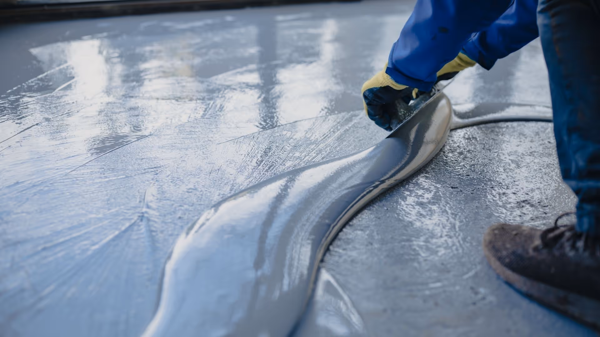 Close up of basement floor coating being smoothed out