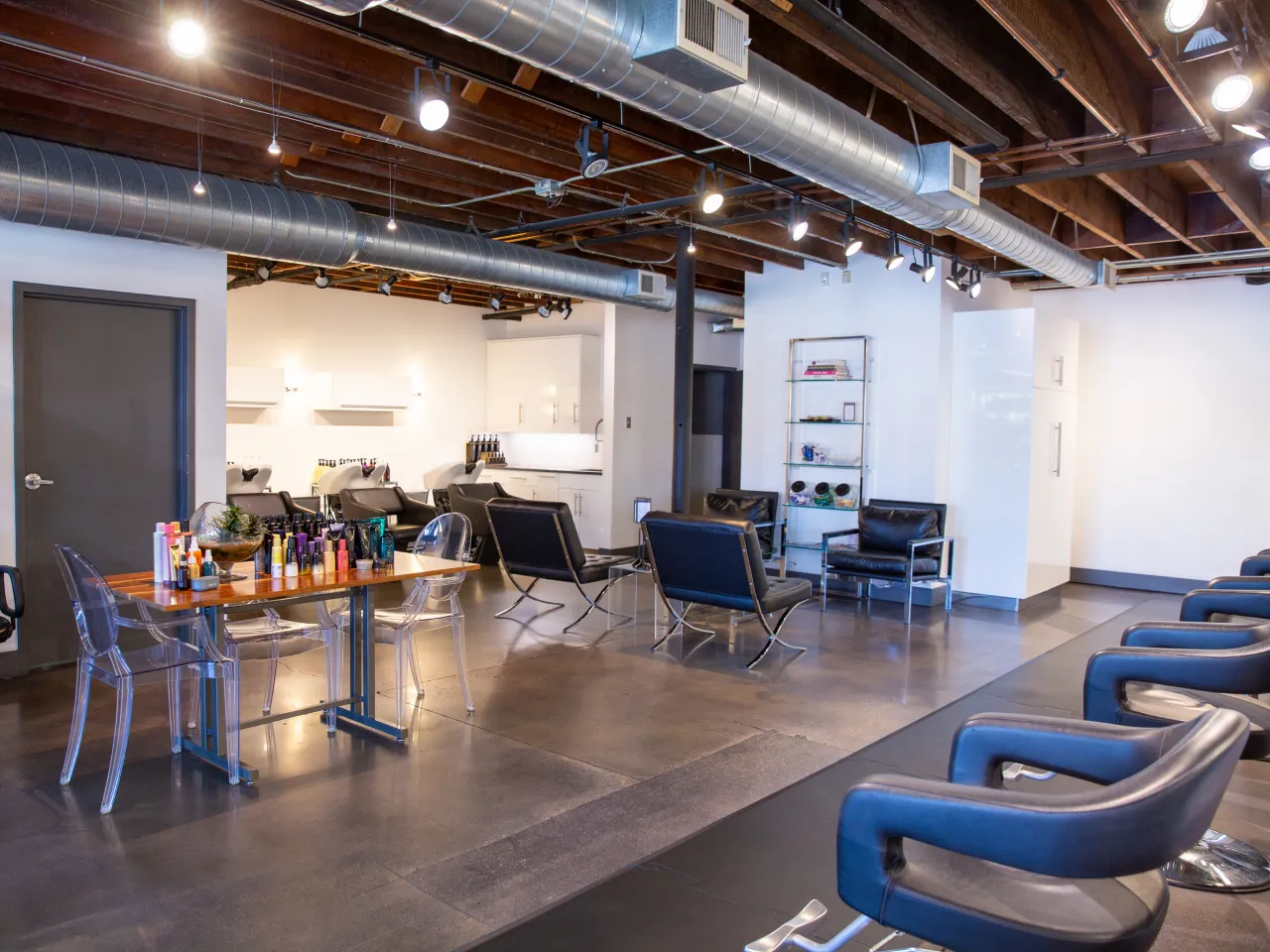 Elegant salon workspace at B. Young Salon showcasing professional styling stations with modern industrial design elements
