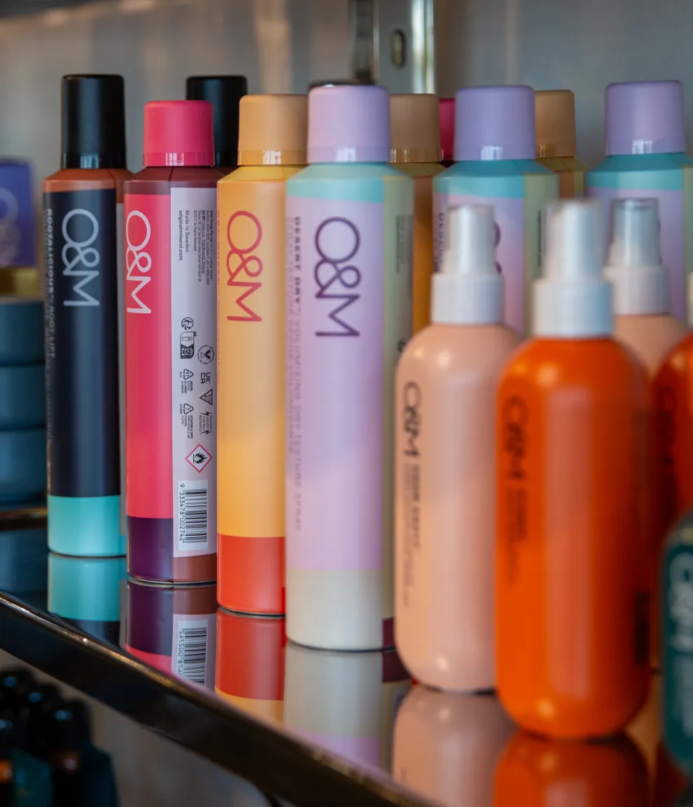 B. Young Salon Original & Mineral hair products displayed beautifully on a shelf in their modern Old Town Wichita salon.
