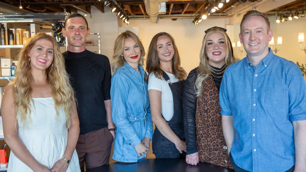 Professional team of expert hair stylists at B. Young Salon Wichita posing together in the salon's modern interior