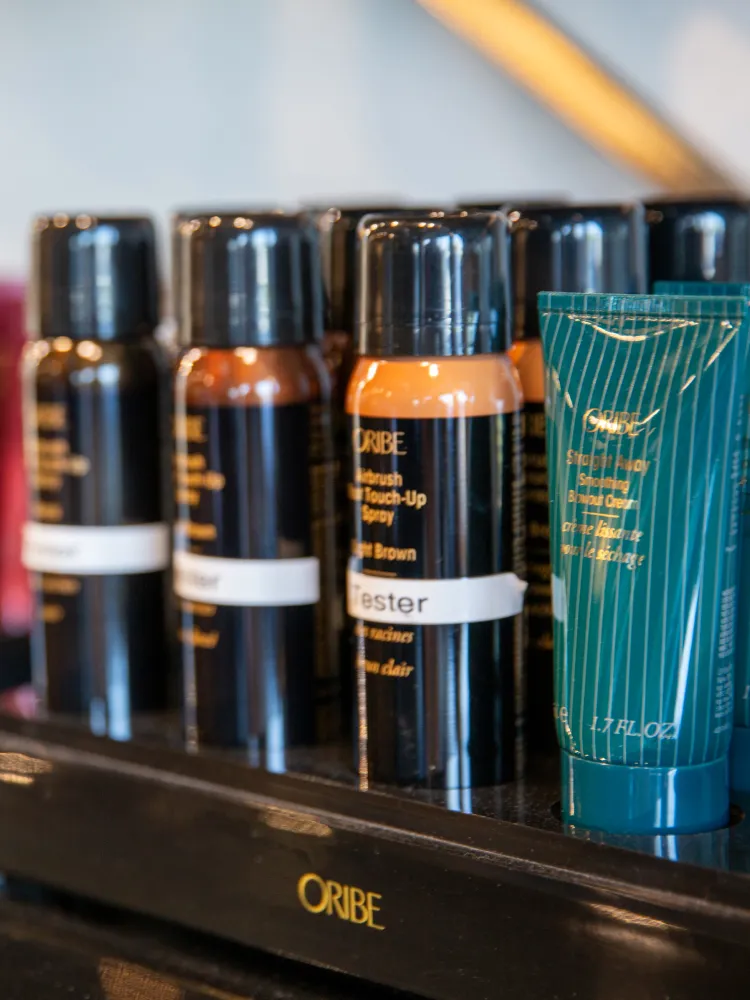 B. Young Salon Oribe hair products displayed beautifully on a shelf in their modern Old Town Wichita salon.