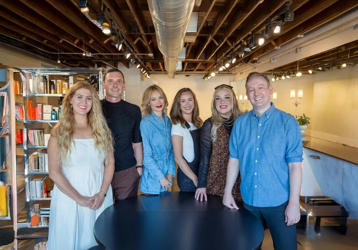 Professional team of expert hair stylists at B. Young Salon Wichita posing together in the salon's modern interior