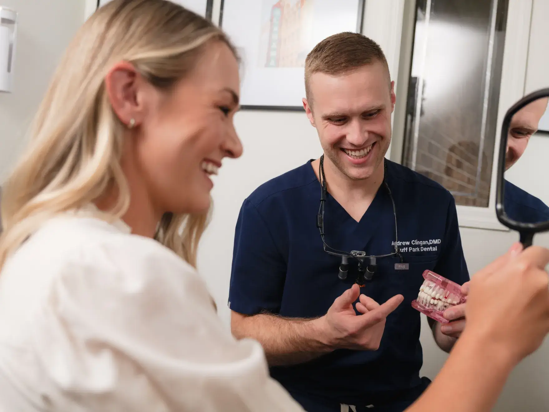 Dr. Clingan showing denture to patient