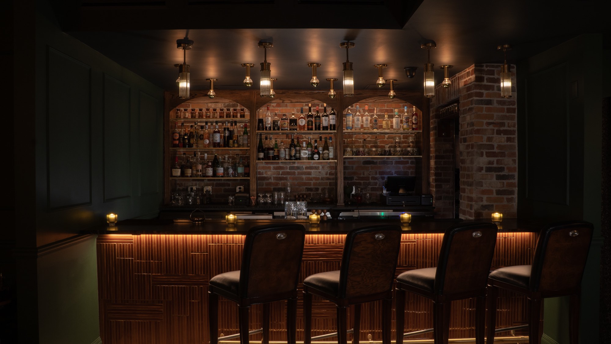 Illuminated bar and stools at Brass Monkey Lounge