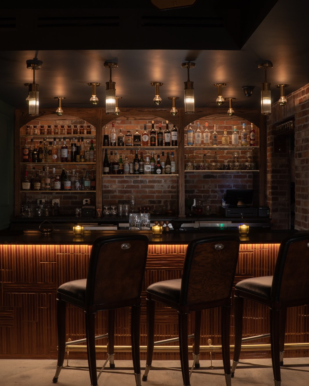 Illuminated bar and stools at Brass Monkey Lounge