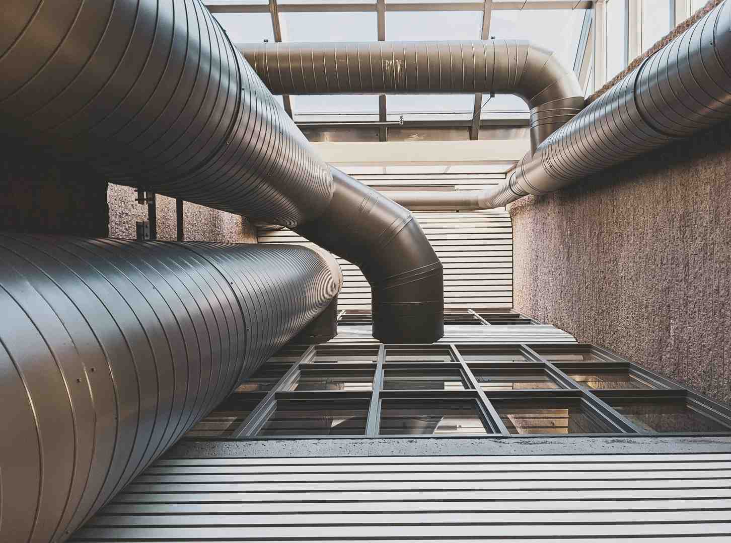 Technicians installing commercial ductwork in ceiling Technicians installing commercial ductwork in ceiling