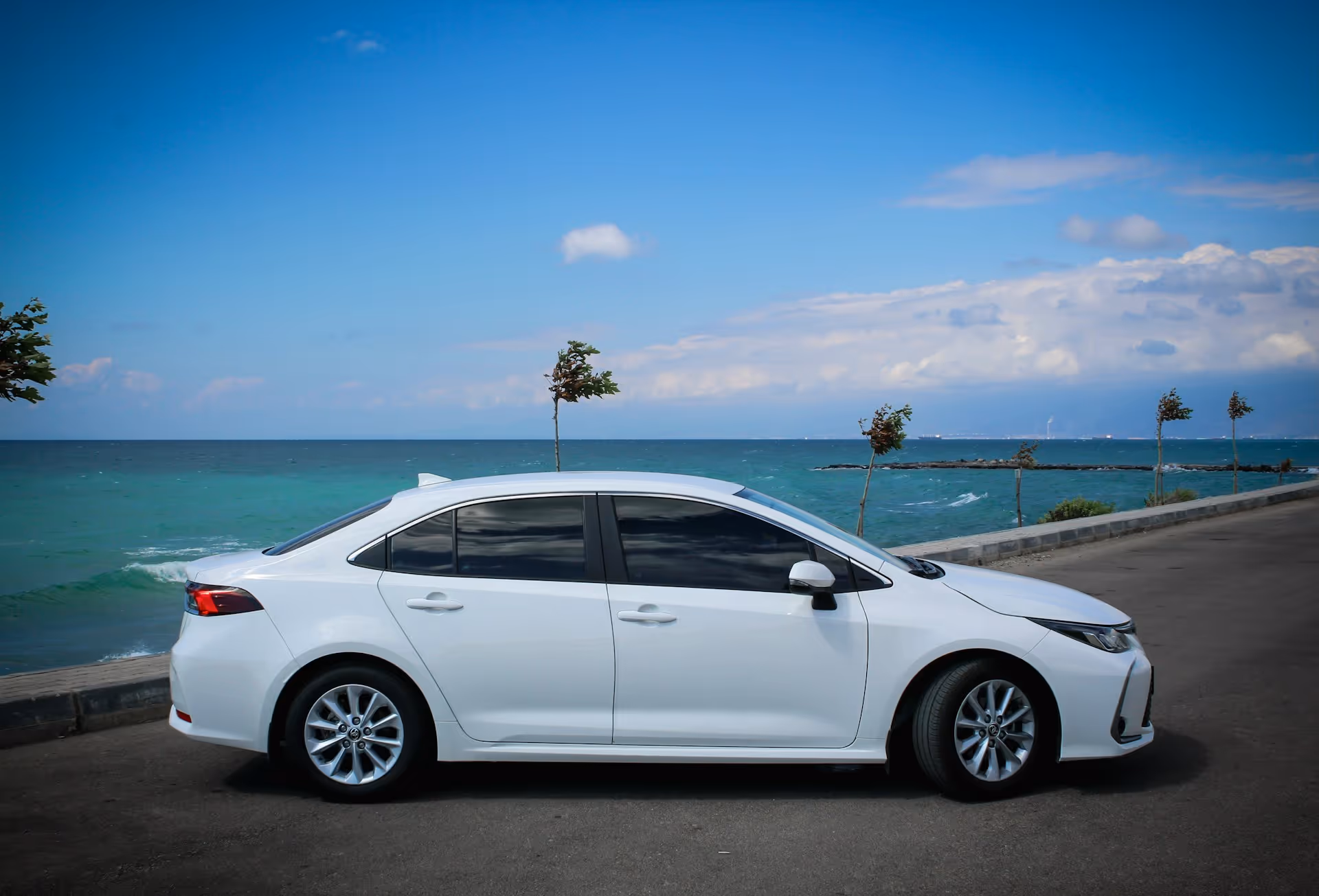 White sadan by the ocean