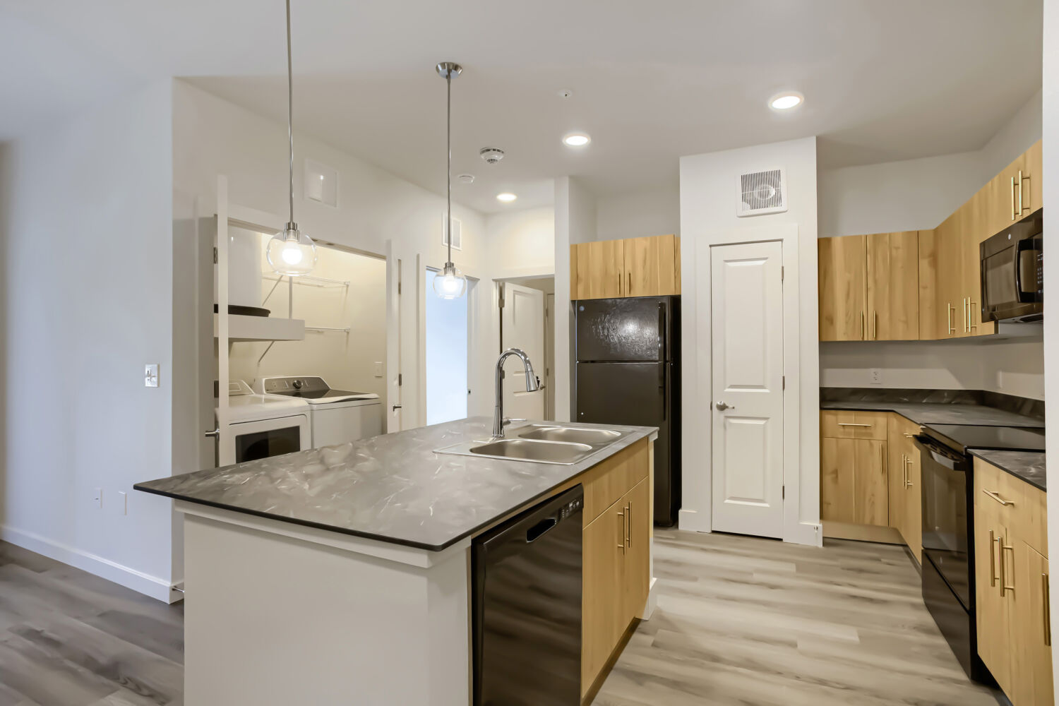 Kitchen with island and black appliances