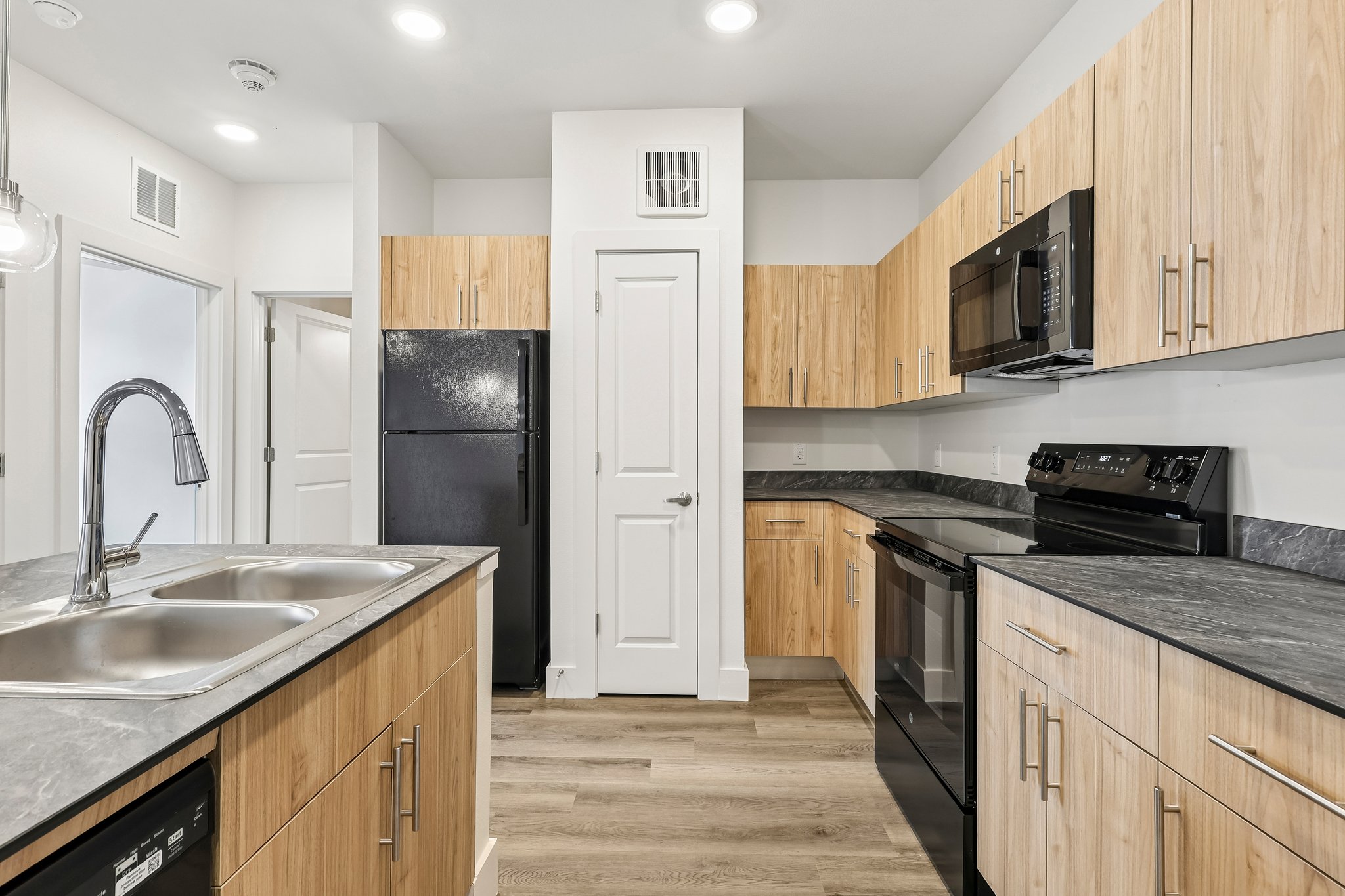 kitchen with woodlike cabinets and dark counters