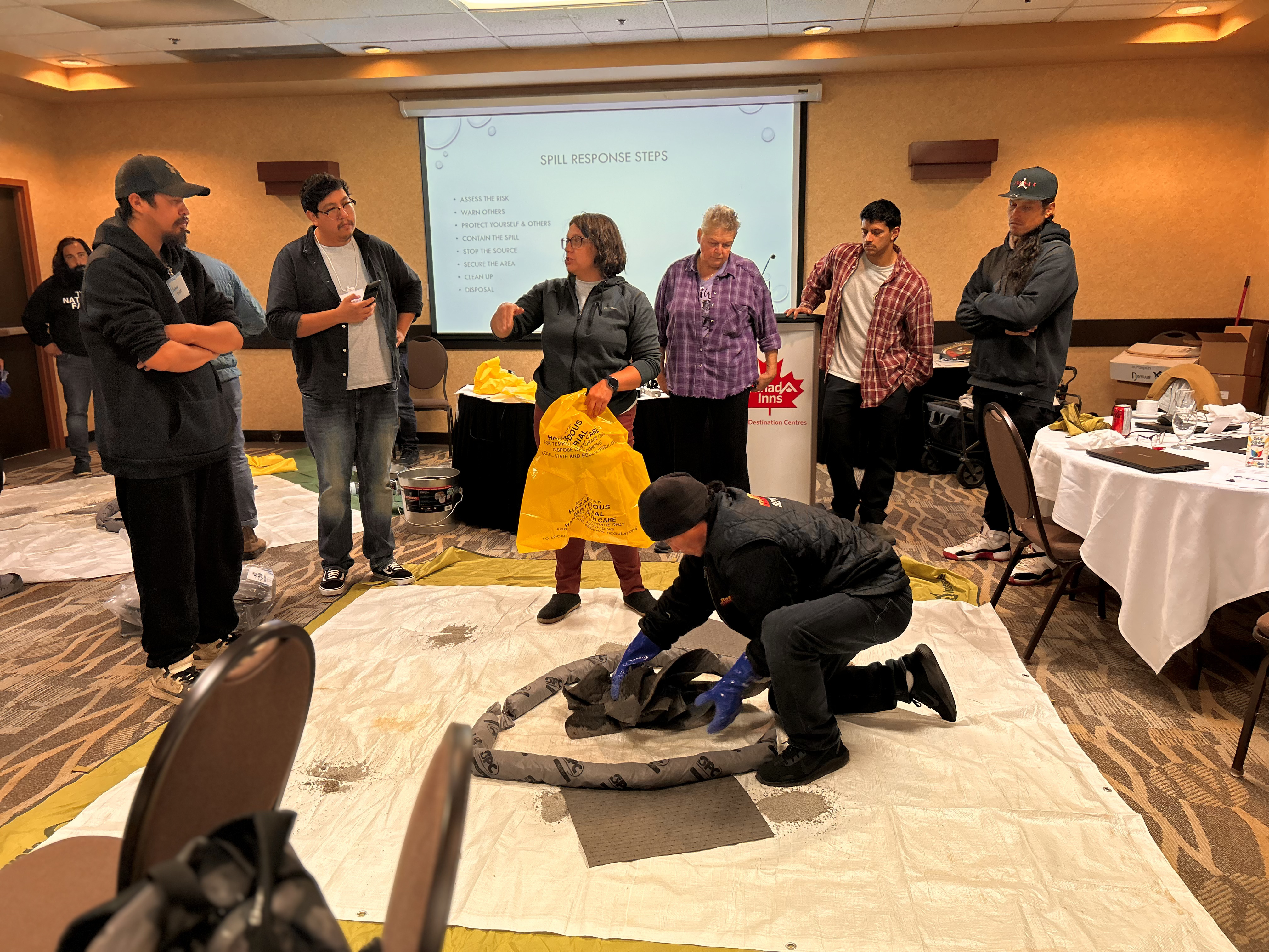 A person demonstrates proper spill response protocol