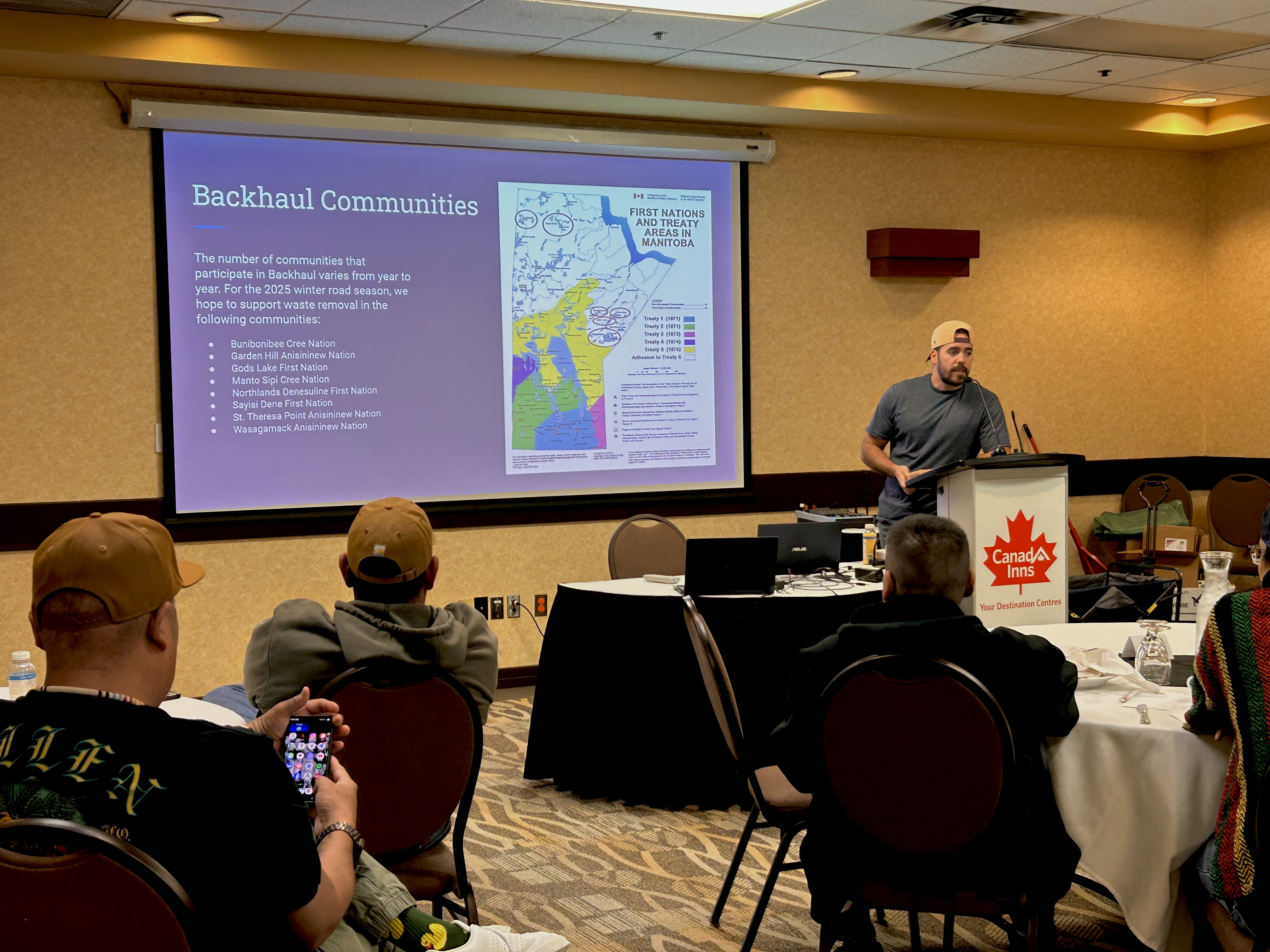 A conference group looks at slides on a projector