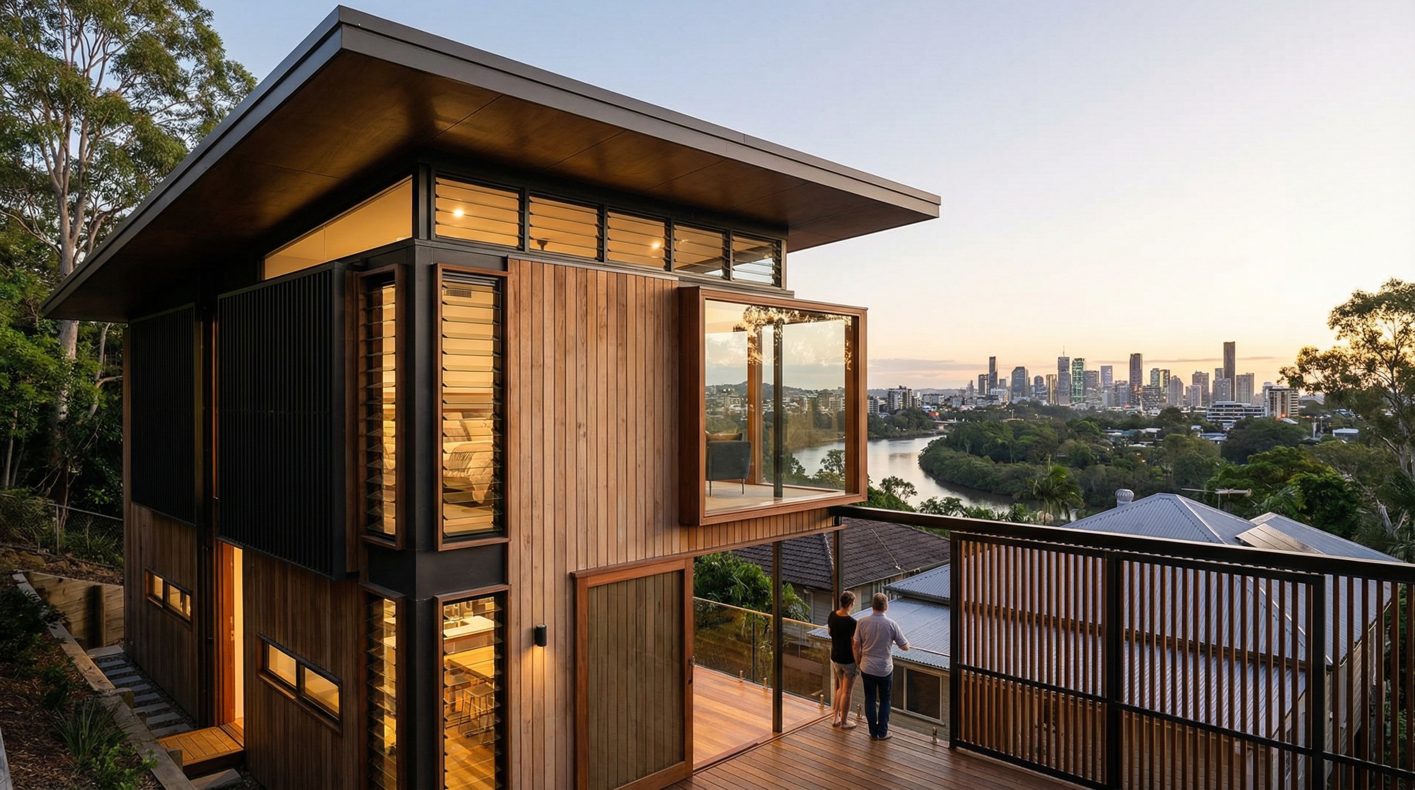 Quorum Studios, Brisbane residential architects — contemporary timber and louvre hillside home at dusk with cantilevered deck and Brisbane River city views