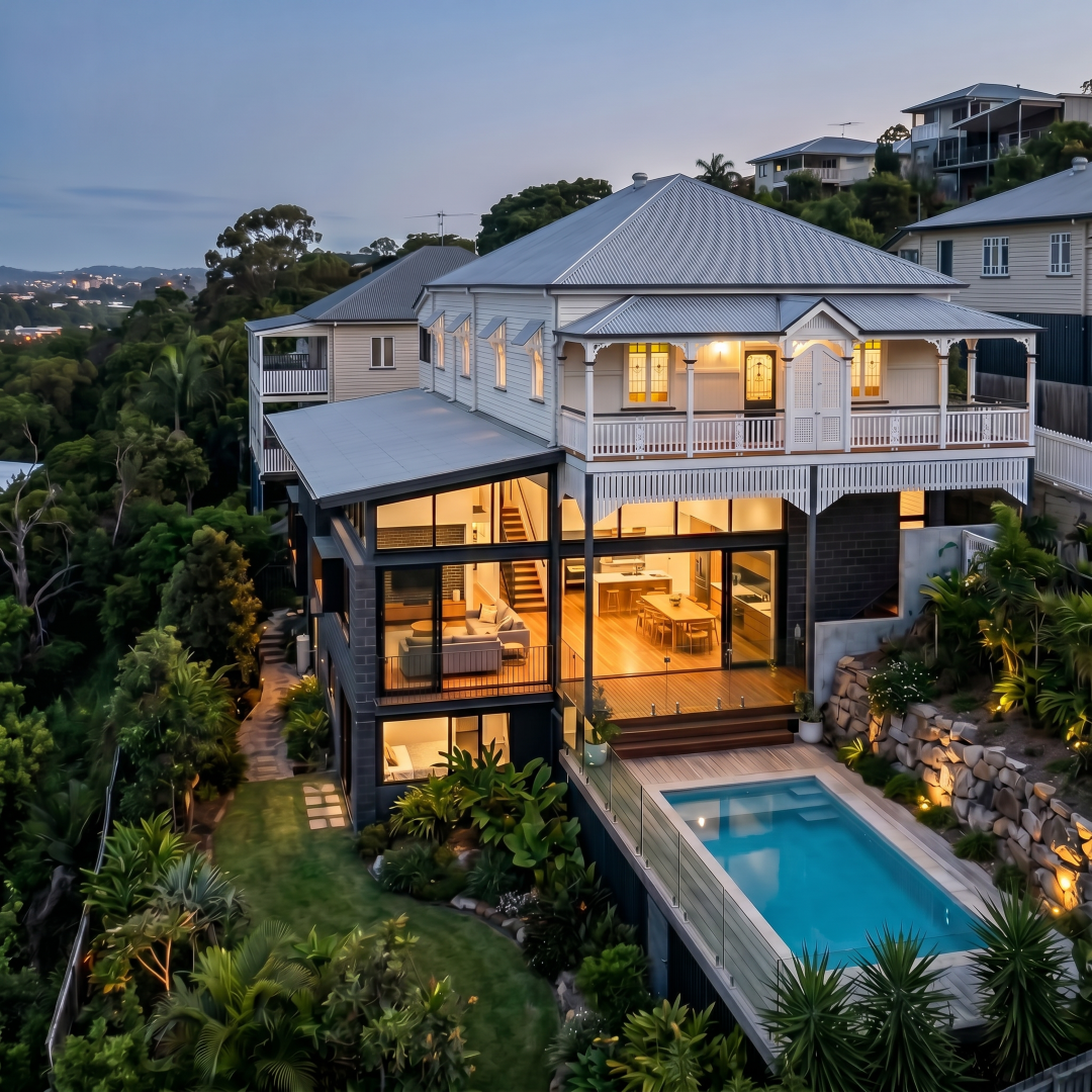 Contemporary home beside a heritage Queenslander on Hamilton Brisbane hillside — concrete and glass in a heritage overlay area, renovation architect Brisbane