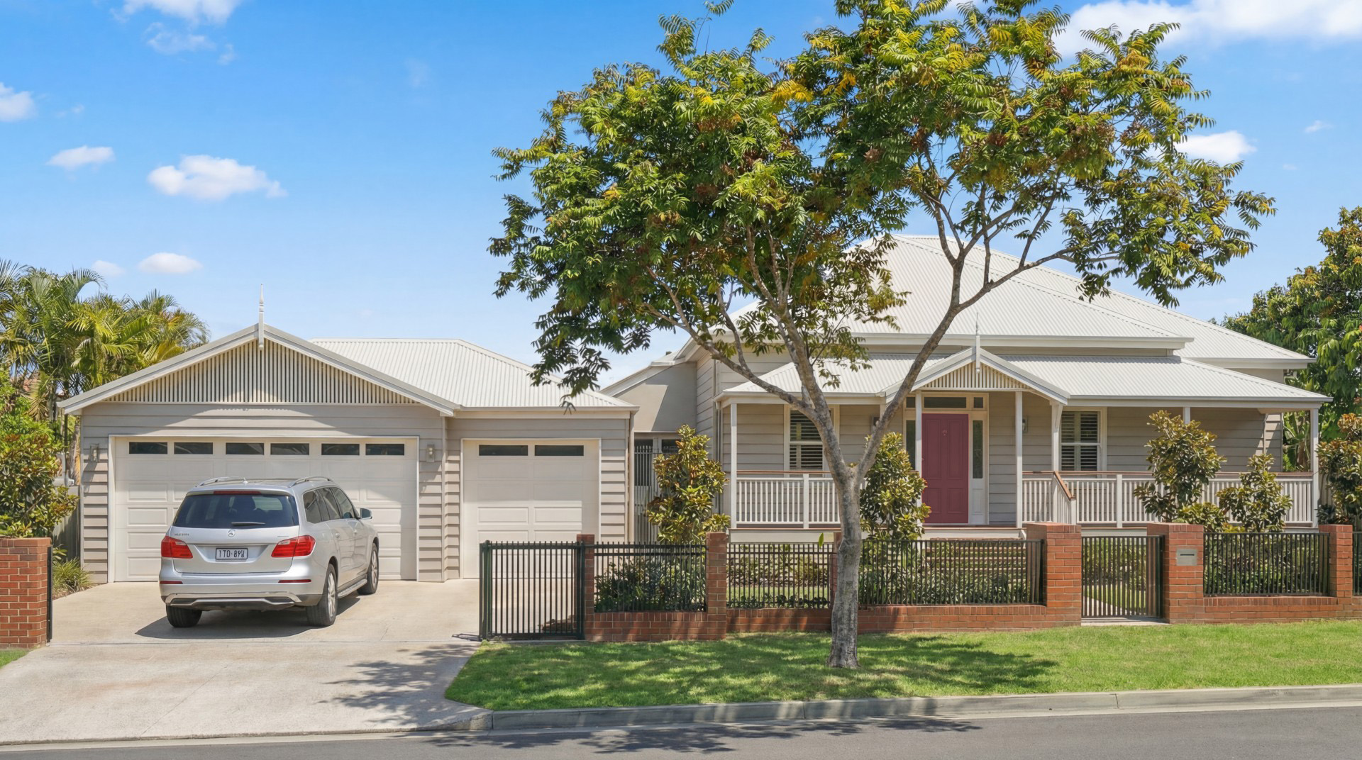 Queenslander street front in Tingalpa, Brisbane, with a new garage designed to match the original home