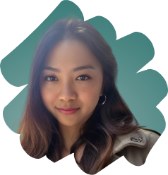 Portrait of a young woman with long dark hair wearing hoop earrings and a beige jacket, smiling softly.