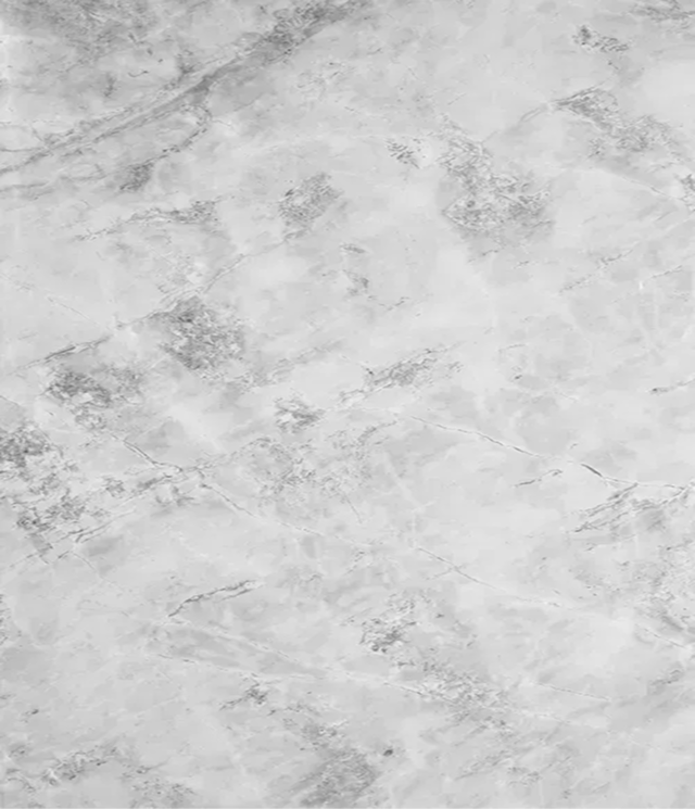 Close-up of white marble surface with grey veining and texture.