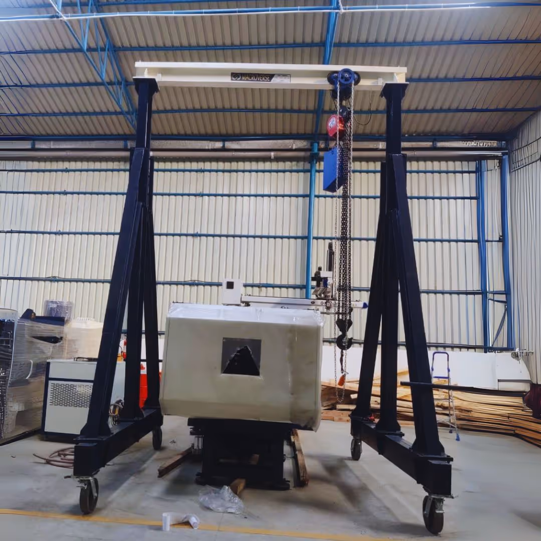 Two workers on blue lift inspecting a yellow overhead crane inside a large industrial warehouse.