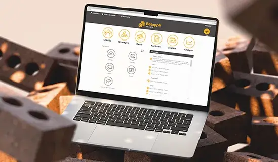 Batappli sur l'écran d'un ordinateur portable macbook posé sur des briques en terre cuite
