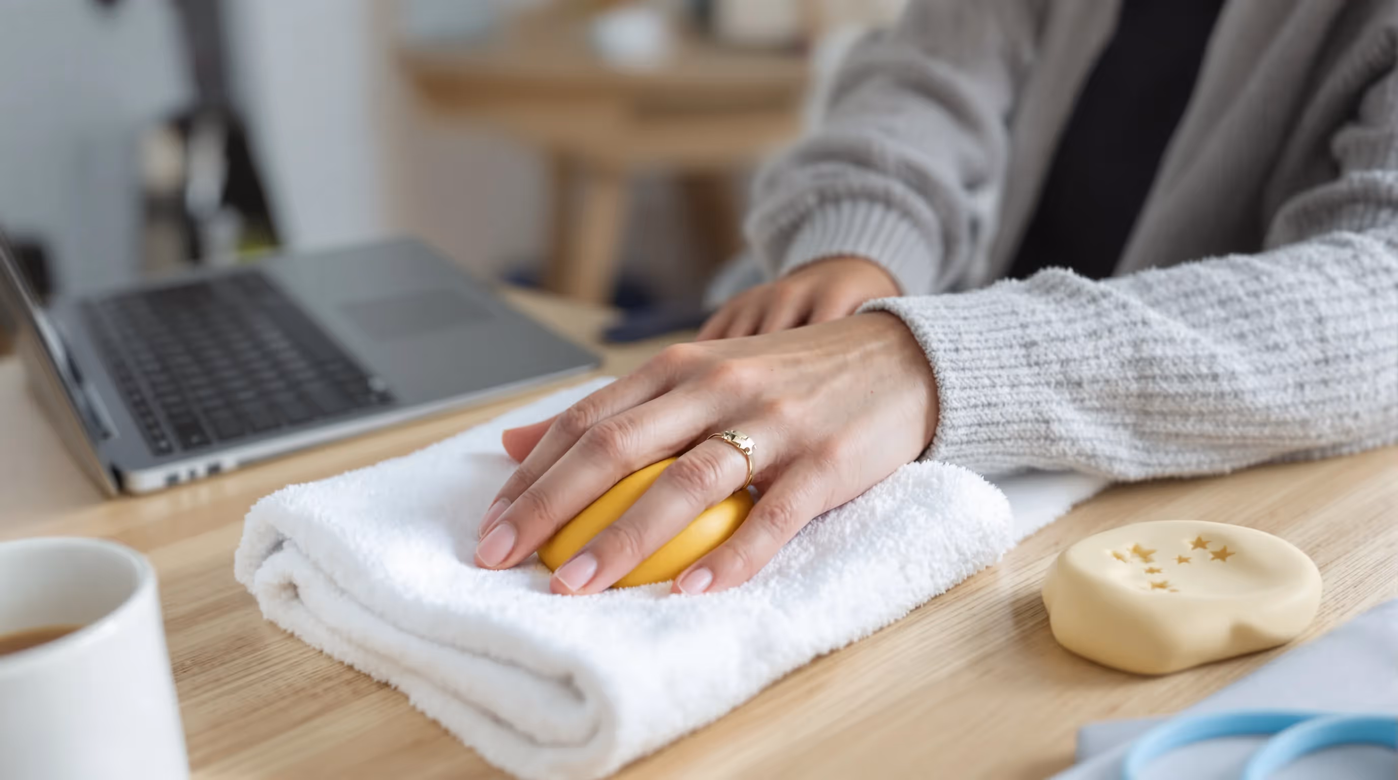 Woman performing gentle wrist isometric for ulnar nerve with foam ball.