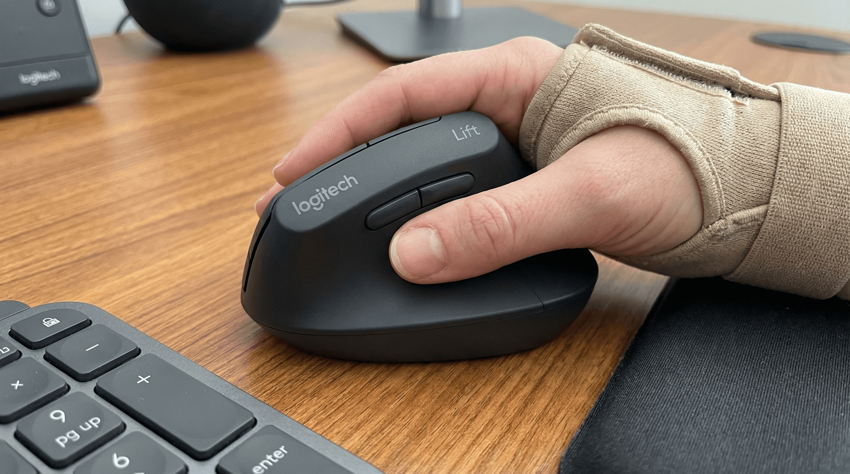 Small hand using a fixed-angle vertical mouse for ulnar nerve relief.