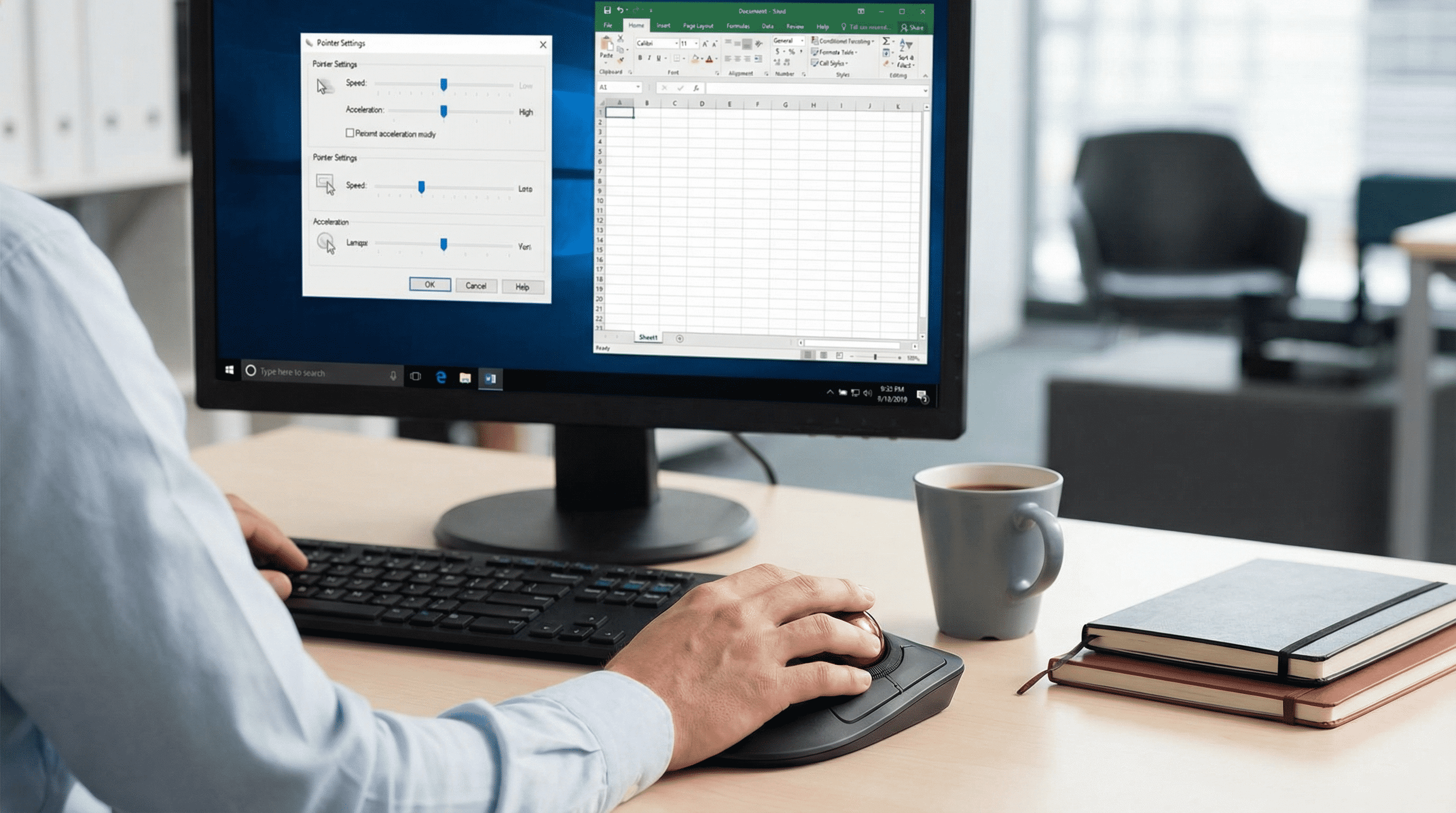 Over-the-shoulder view of a desk showing pointer settings and central trackball.