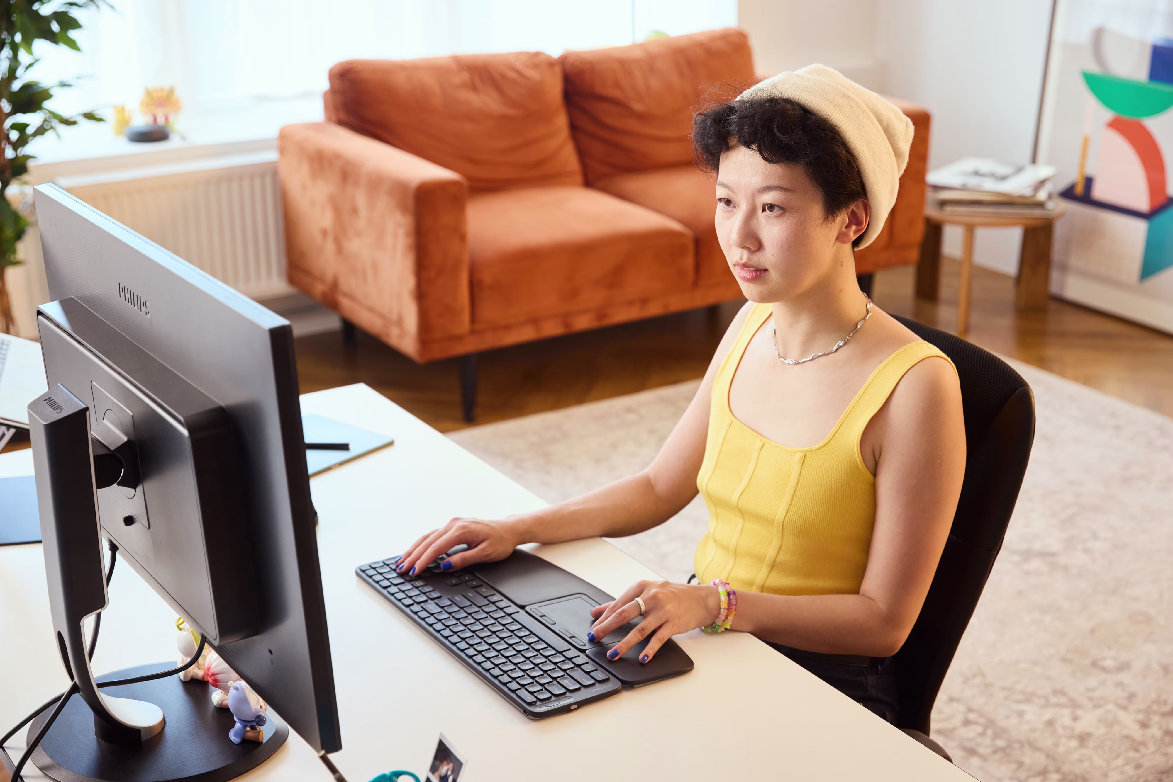 British office worker doing neck glide with centered contour touchpad and relaxed shoulders.