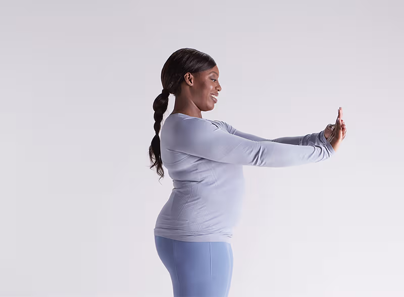 British office worker doing an ulnar nerve glide at her desk.