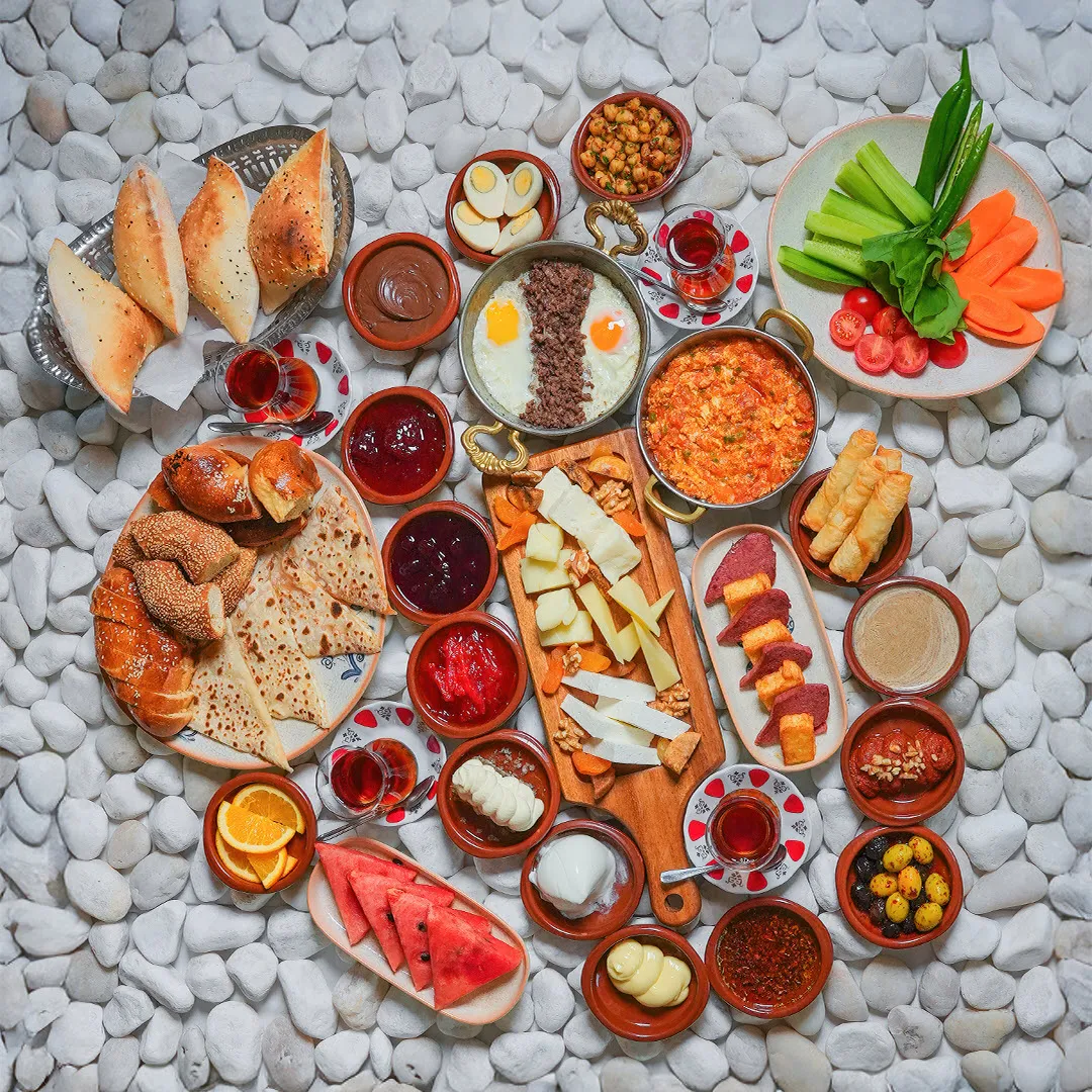 Traditional Turkish breakfast spread with tea and breads