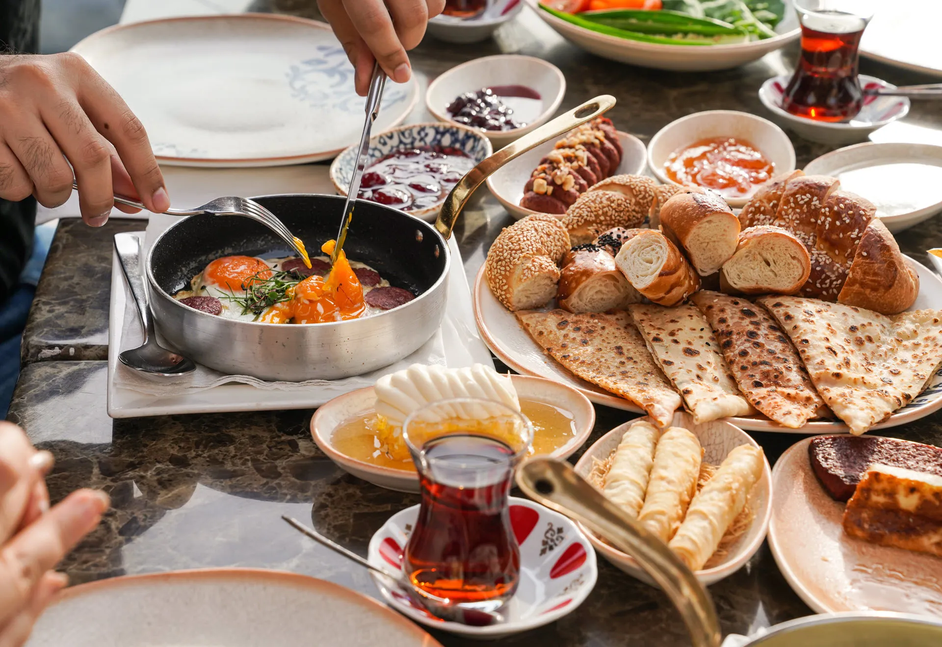 Traditional Turkish breakfast spread with tea and breads