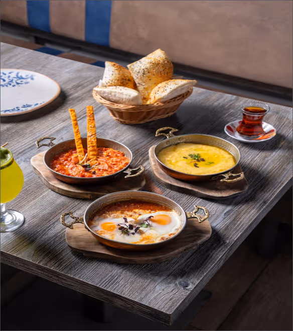 Traditional Turkish Food spread including lentil soup, kebabs, and baklava at Turkish Village restaurant in Dubai