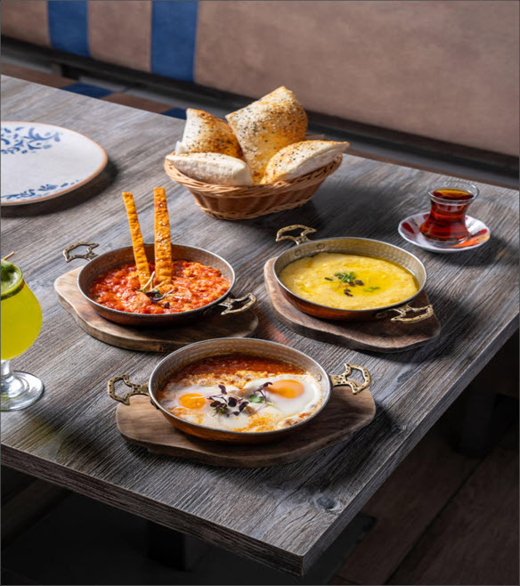 Traditional Turkish Food spread including lentil soup, kebabs, and baklava at Turkish Village restaurant in Dubai