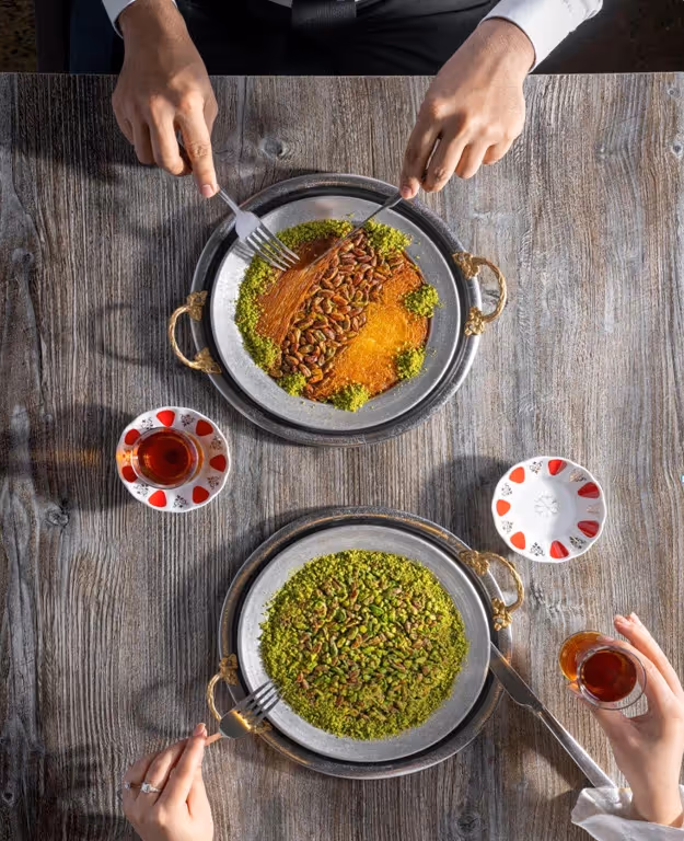 Family enjoying traditional Turkish dinner at Turkish Village, the best restaurant for a family dinner in Dubai with shared plates and authentic hospitality