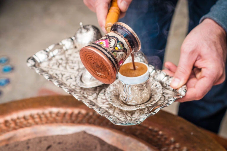 Traditional Turkish tea being served in ornate cups at Turkish Village Dubai