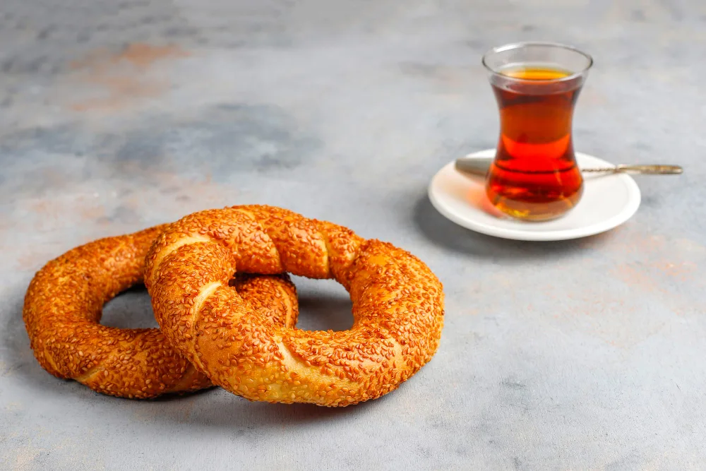 Turkish simit with Turkish coffee on a white saucer