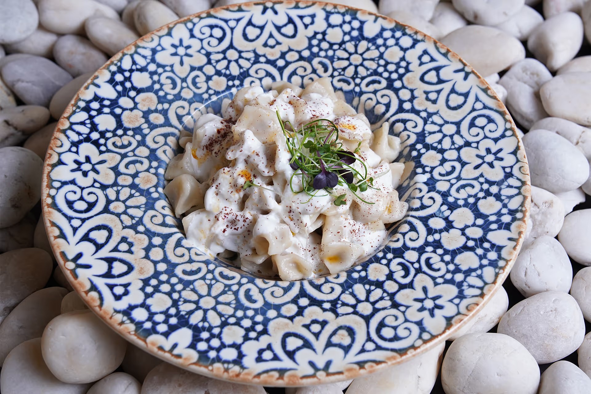 Turkish manti dumplings topped with garlic yogurt and spices at Turkish Village in Dubai