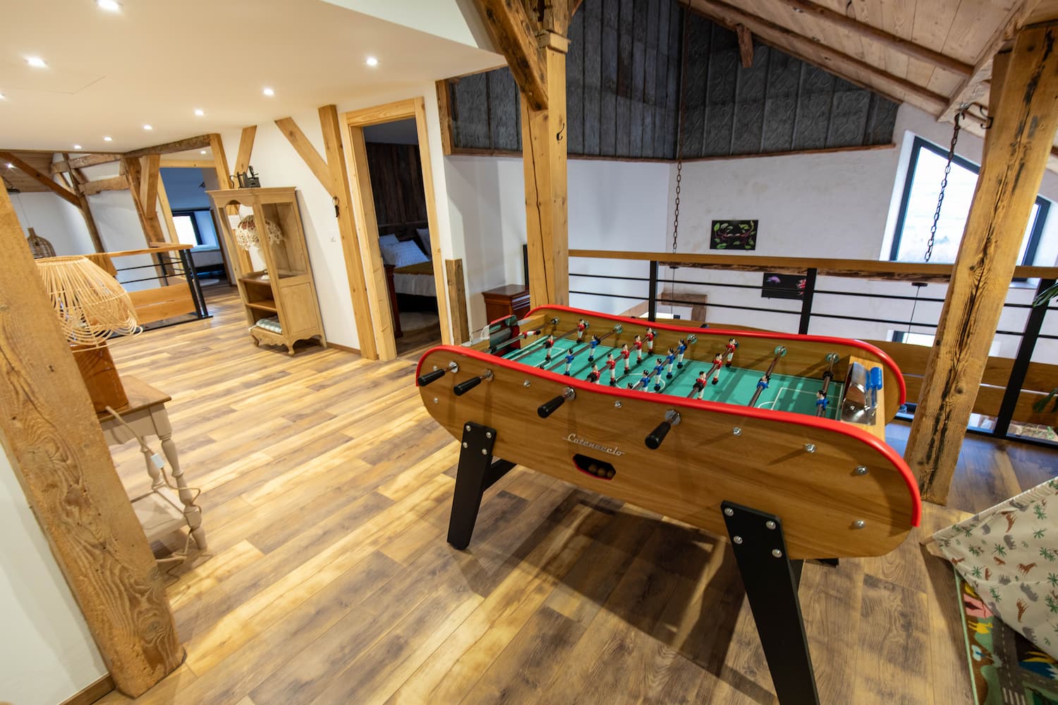 Modern bathroom with two rectangular white sinks on a wooden vanity, round rattan mirrors, a freestanding white bathtub, and beige tiled walls and floor.