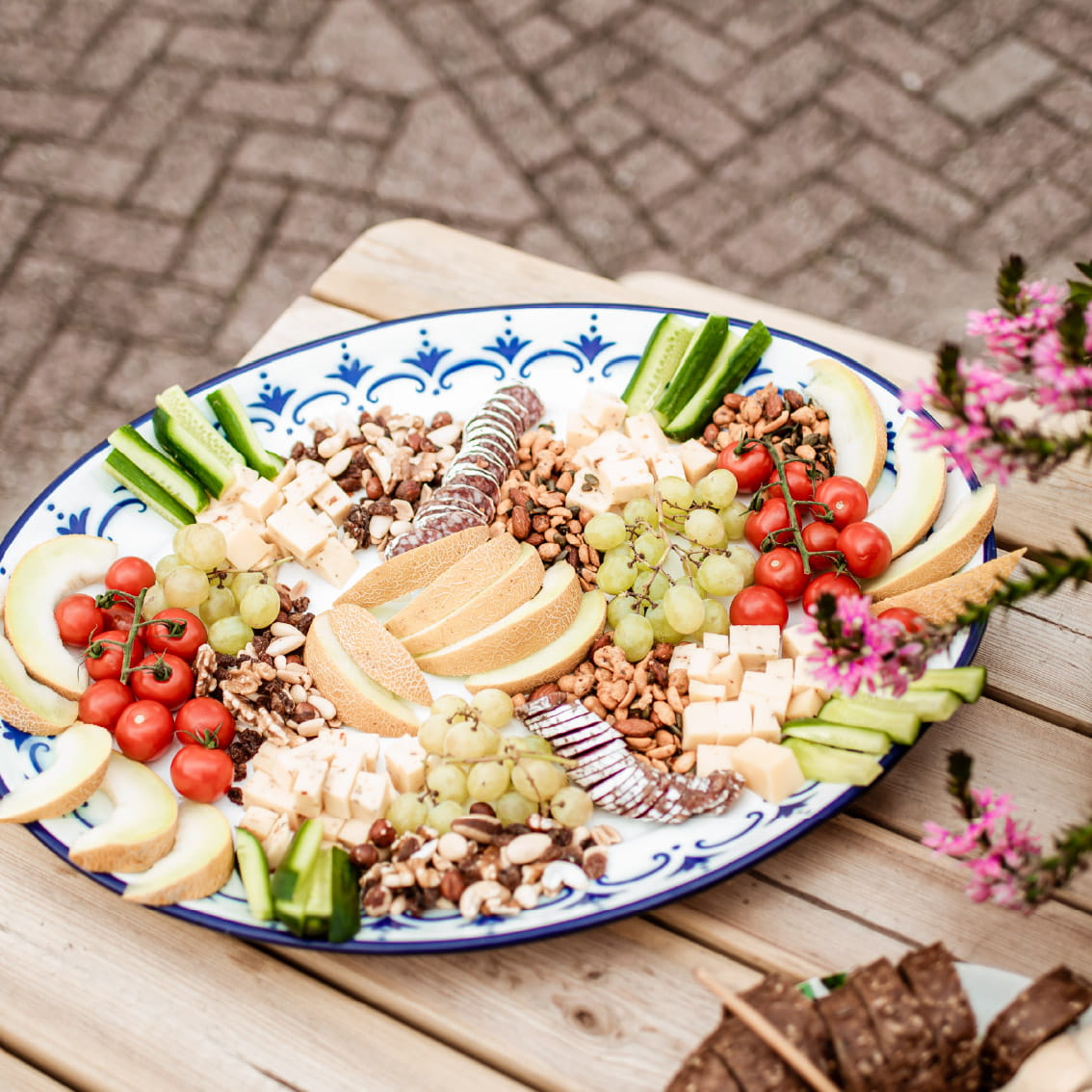 Borrelplank met kaas, fruit, noten en charcuterie tijdens een zomers groepsuitje op de Utrechtse Heuvelrug bij Er Was Eens Woudenberg.