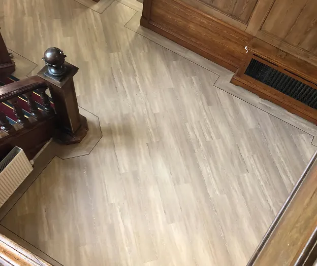 An overhead view of a wood floor and stairs.