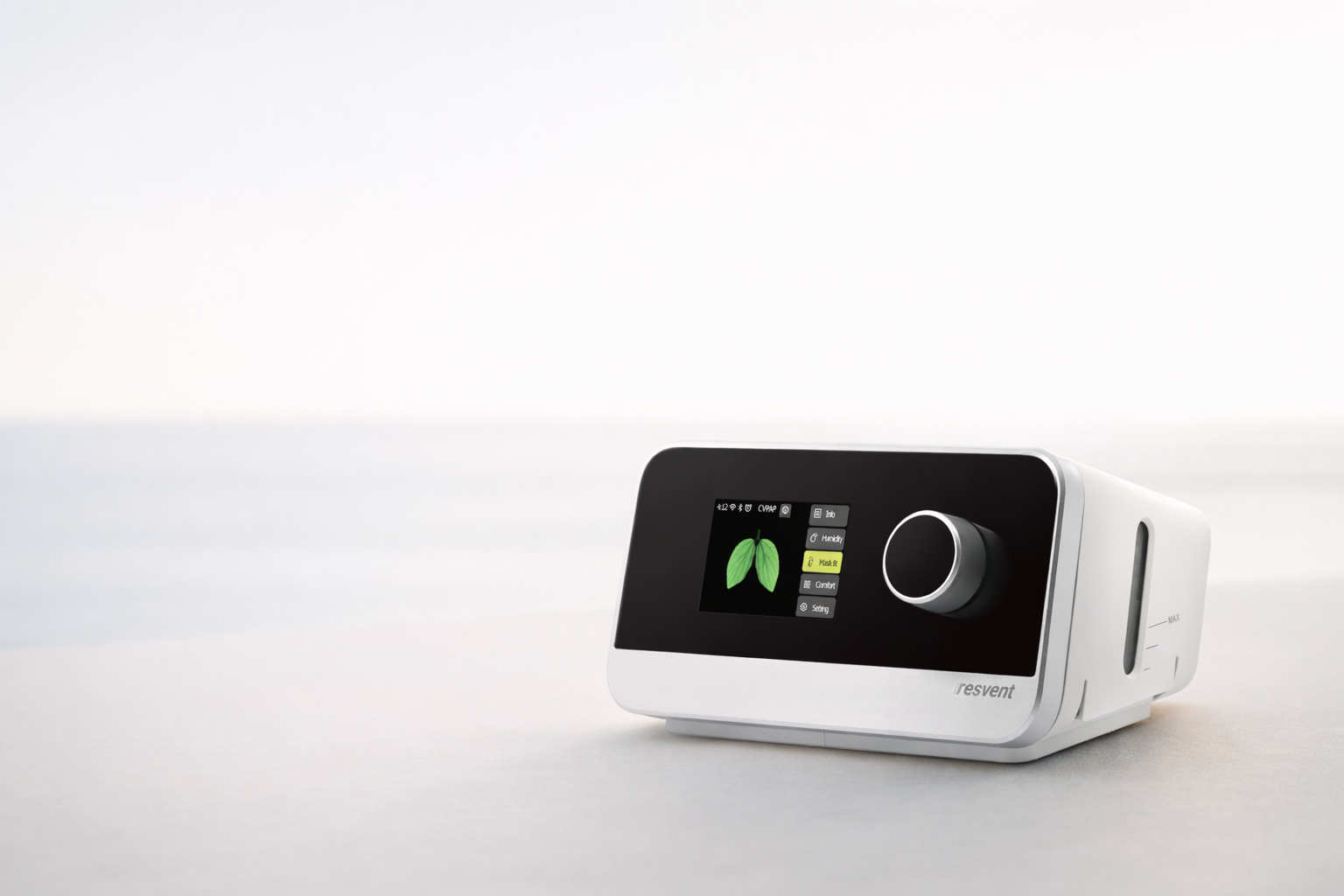 White Resvent CPAP machine with digital display showing lung icon and menu options on a light background.