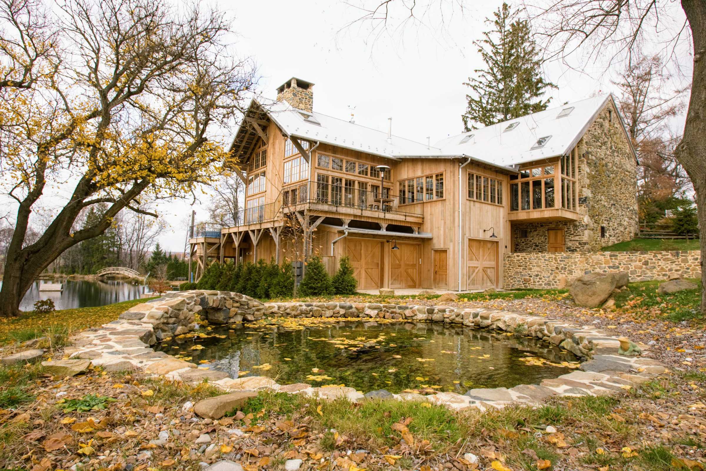 Multi level deck by barn-house. Original stone wall.