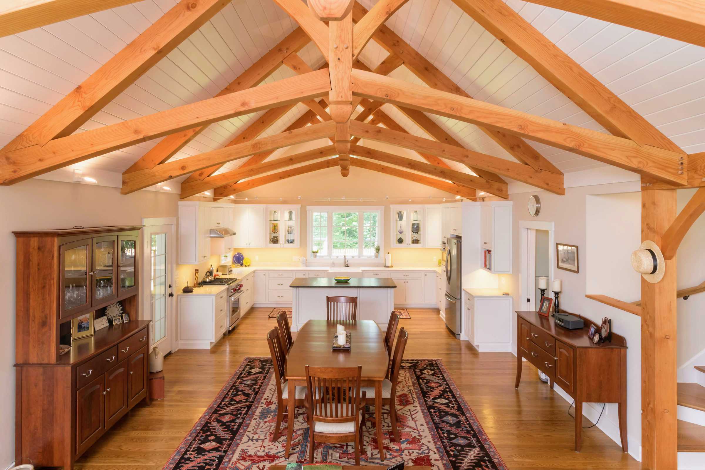 Timber frame great room, kitchen and dining room with open floor plan.