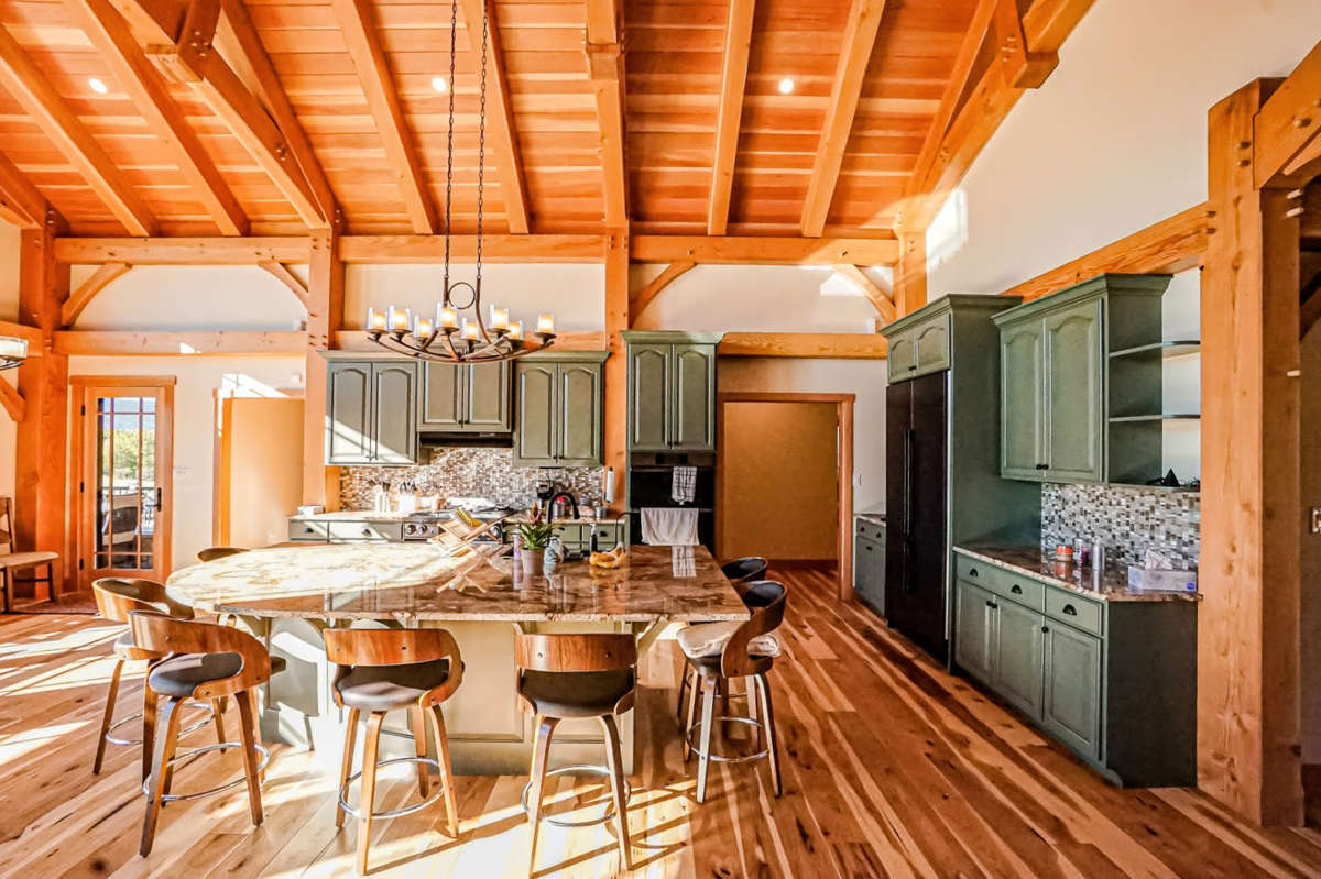 Kitchen with island and bar, all part of the great room.