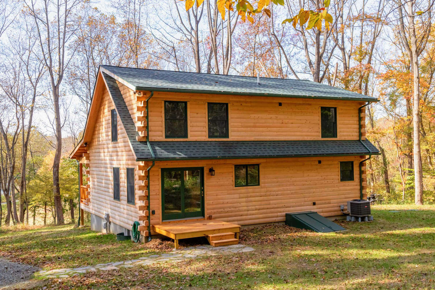 Katahdin cedar log cabin with upstairs dormer.