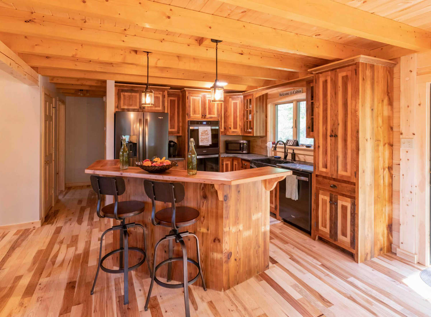 Rustic kitchen with bar in a custom log home.