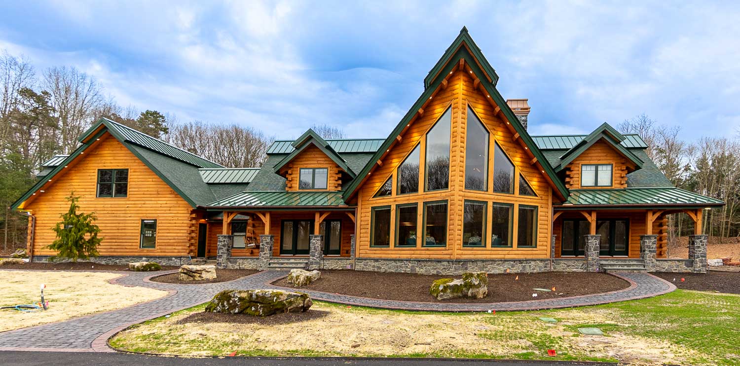 Custom log home with large prow front and accent roof