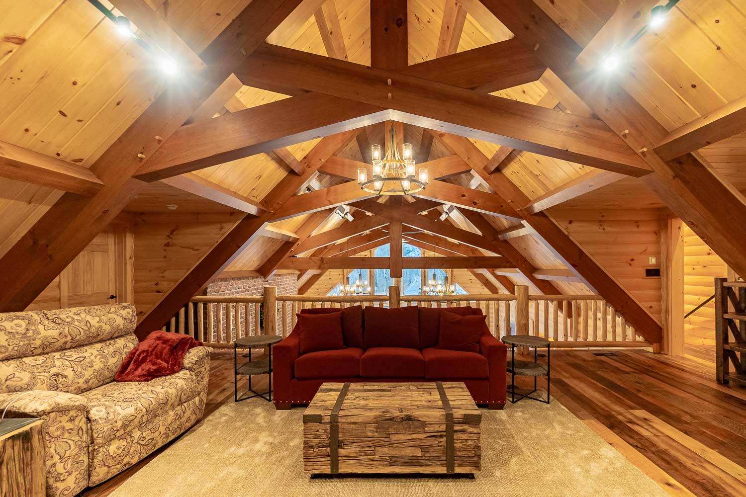 Large loft sitting area with unique timber frame trusses