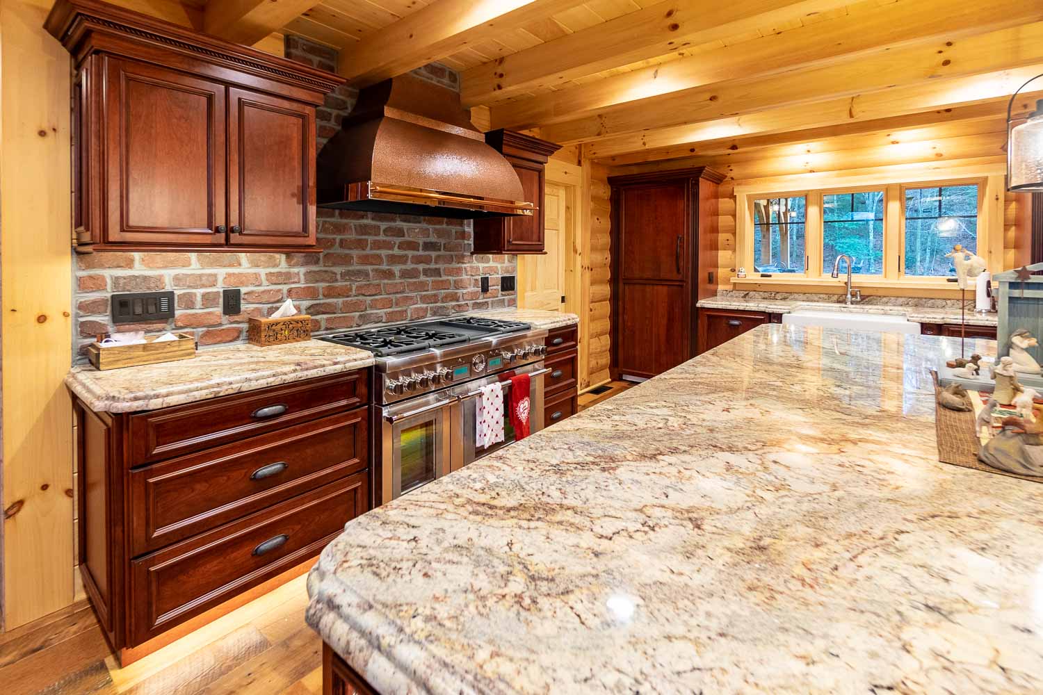 Granite countertops, large range with copper vent hood