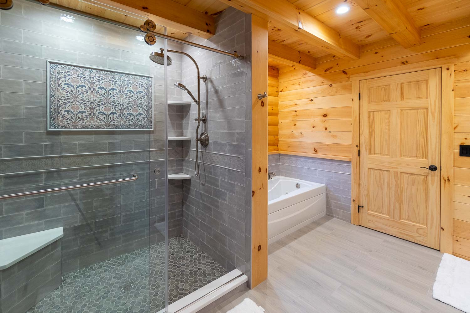 Large shower with beautiful tile work and large soaking tub