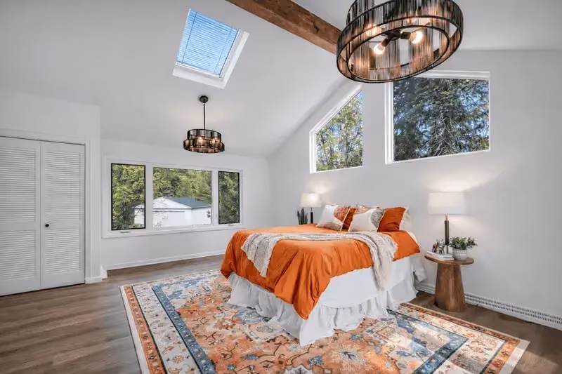 Completed Cleveland home renovation bedroom with exposed beams and modern lighting